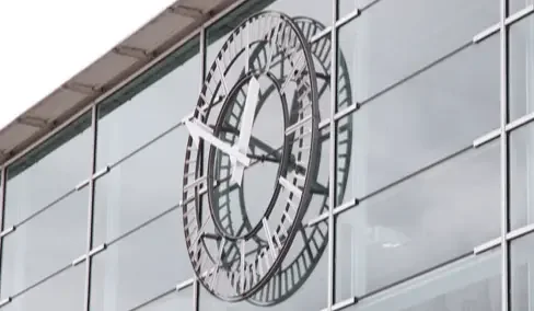 Skeleton tower clock mounted on a building facade
